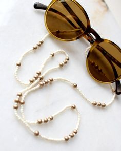 More Sunglasses + MASK Chain, please visit the link below,https://www.etsy.com/shop/ShopSolJewelry/edit?ref=edit_trust_header&section_id=29876749white seed beads glasses chain gold multi beads glasses chain ethnic boho chic sun glasses chain necklace  mask chain necklace 28-30" total length**framed gems, and charms in the jewelry is plated.*All the jewelry in my shop will be sent in cotton pouch.If you want gift box wrapping, please let us know :), we will send your jewelry in gift box. Beads Sunglasses, Boho Glasses, Beads Glasses, Boho Sunglasses, Beaded Sunglasses, Box Wrapping, Eyeglass Necklace, Sunglasses Chain, Mask Chain