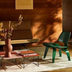 a living room filled with furniture and a vase on top of a wooden coffee table