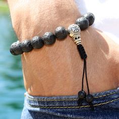 "It does not matter how deep you fall; what matters is how HIGH  you bounce back. This Lava Rock wrist mala will give you strength and courage, allowing you stability through times of change. In addition, it will provide you guidance and understating in situations where you need to \"bounce back.\" This lovely wrist mala bracelet is made with 8 mm or 10mm lava rock beads, 10 mm Silver Tibetan Guru bead, and 6 mm Lava rock beads pull ends. With an adjustable slide cobra knot. The Sliding knot closure makes the mala flexible approx 6-7cm, to allow going over the hand. 18 or 21-bead mala bracelet is a miniature, wrist-worn version of its larger counterpart, the 108-bead mala necklace. Perfect for beginners, you can work your way up! Perfect as a planned gift for a friend, loved one, or yourse Adjustable Lava Stone Beaded Bracelets, Adjustable Lava Stone Stretch Bracelet For Meditation, Adjustable Lava Stone Bracelet For Meditation, Casual Adjustable Lava Stone Beaded Bracelets, Casual Adjustable Bracelets For Meditation, Adjustable Silver Lava Stone Bracelets, Adjustable Hand-strung Lava Stone Bracelet, Adjustable Lava Stone Stretch Bracelet Gift, Cobra Knot