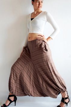 Beautiful double layer fabric made of cotton/linen blend.  High quality and stunning beauty. The fabric is unbleached and undyed, you can see the bark fibres in it! Subtle stripe patternDrop-crotch style pants, baggy pants, tribal pants with a twist.3 ways to wear. with drawstring on the hem. You can wear it with drawstring loose. Like a wide leg pants. Even look like A shape sweet skirt.You can also draw the string and get a balloon shape pants.Or...you can put the hem above your knee and get a Spring Hippie Harem Pants With Relaxed Fit, Cotton Harem Pants For Fall Loungewear, Spring Hippie Relaxed Fit Harem Pants, Cotton Harem Pants For Loungewear In Fall, Hippie Relaxed Fit Harem Pants For Spring, Relaxed Fit Hippie Harem Pants For Spring, Non-stretch Cotton Harem Pants For Fall, Baggy Bohemian Loungewear Bottoms, Non-stretch Cotton Harem Pants For Loungewear