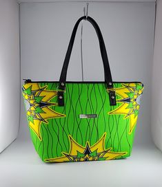 "\"Bag description:  This lovely bag is a perfect size for any occasion, with ample room for all your essentials when shopping, going to the office or on an evening out. Brighten up your day with this green and yellow vibrant bag and change the mood around you.   This tote bag is a combination of Ankara African fabric and faux leather, fully lined waterproof canvas fabrics. The handles are long enough to fit comfortably on the shoulder or held by hand. Internally, this bag is fully lined with waterproof canvas and zippered pocket which fits your phone or other valuables. This bag is closed with a durable zip. Bag Style: Tote Fabric: African Wax Print Fabric - Ankara green and yellow print fabric. 100% Cotton Lining: Waterproof canvas Hardware: Chrome  Handles: 24 inches in black faux leath Green Hobo Bag With Adjustable Strap For On-the-go, Trendy Green Satchel Canvas Bag, Trendy Light Green Bag For Everyday Use, Trendy Green Satchel For Travel, Trendy Green Pouch Bucket Bag, Trendy Green Canvas Bag With Removable Pouch, Casual Green Pouch-shaped Bucket Bag, Green Handheld Shopping Bag, Casual Green Pouch Bucket Bag