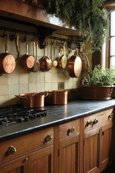 pots and pans are hanging on the kitchen wall