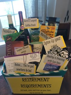 a box filled with wine bottles and cards on top of a wooden table next to a window