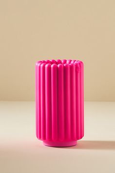 a pink vase sitting on top of a table