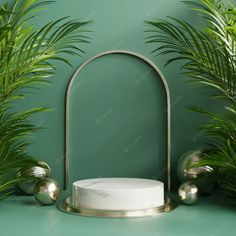 a white cake sitting on top of a green counter next to potted palm trees