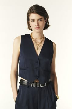 Gender-bending fashion is all the rage, as evidenced by our trendy CORALI vest. This ba&sh exclusive is designed with an elongated V-neckline highlighted by buttons and pointed tails. It also features side pockets and a thin adjustable rear belt. Wear this vest over a button-down shirt with a suit for a sophisticated style, or with a T-shirt and sneakers for a casual look. This item is made with recycled synthetic fibers - Vest- Buttoned- Side pockets- V-neckline Style Androgyne, Strappy Tops, Gender Bending, Synthetic Fibres, Androgynous Fashion, Pump Dress, Mode Inspo, Knitwear Tops, Shoes With Jeans