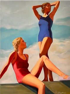 two women in swimsuits are sitting on the edge of a cliff and one is standing