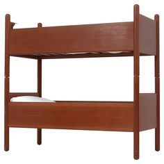 a wooden bunk bed with two white pillows