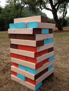 a stack of wooden blocks sitting on top of a grass covered field