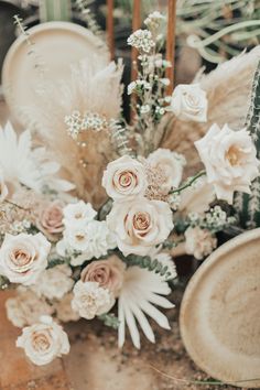 a vase filled with lots of flowers on top of a table