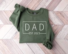 "Customized Dad Est Sweatshirt, Dad Sweatshirt, Gift for Dad, Gift for Grandpa, New Dad shirt , Father's Day Gift, Birthday Gift Dad ----- About Us ----- All TeaShirtUS shirts use the highest quality material for ultra-soft and comfortable wear. Most importantly all of our shirts are printed using the most advanced apparel printer to ensure vibrant colors and detailed graphics. ----- How To Order ----- 1-) Please, check and review all the photos. 2-) Choose your t-shirt size and color. *Different styles of shirts may have different shades of same color choice due to different manufacturer brands. *For this reason, we recommend you to match shirts from the same styles if you want precisely matching colors (ex. Unisex, V-necks, Toddler, etc.). 3-) Click add to cart. You can go back to add mo Father's Day Crew Neck Sweatshirt As Gift, Father's Day Casual Sweatshirt With Name Print, Father's Day Gift Crew Neck Sweatshirt, Long Sleeve T-shirt With Letter Print For Father's Day, Father's Day Long Sleeve Letter Print T-shirt, Father's Day Long Sleeve T-shirt With Letter Print, Casual Father's Day Gift Sweatshirt, Father's Day Casual Sweatshirt Gift, Father's Day Long Sleeve T-shirt With Name Print