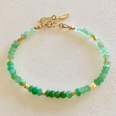 "Lovely natural green chrysoprase gemstone beaded bracelet with 24k gold vermeil accents. Beautiful Australian chrysoprase gems are 4mm faceted rondelles in luscious shades of light to darker apple green. 2mm faceted 24k solid gold vermeil cubes add sparkling accents. Made to order on professional beading wire with 14k gold fill spring ring clasp and findings. A little 22k gold vermeil leaf charm dangles from 1\" extension. Also available in .925 Sterling silver." Green Bracelets With Natural Stones, Green Amazonite Bracelet With Natural Stones, Green Amazonite Beaded Bracelets As Gift, Green Onyx Bracelets - Gift, Green Amazonite Beaded Bracelets With Natural Stones, Green Amazonite Round Bead Bracelets, Green Aventurine Gemstone Beaded Bracelets, Green Rondelle Beaded Spiritual Bracelets, Green Rondelle Bracelets For Jewelry Making