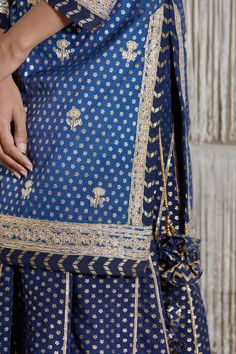 Editor's Note Gota Embroidered Short Chanderi Kurta With Embroidered Georgette Dupatta Color: Navy Blue Fabric: Chanderi And Georgette Embroidery Details: Gota Embroidery Care: Dry Clean Only About the Designer Shyam Narayan Prasad started his journey in the Indian Fashion Design Industry with a couture women’s wear collection. The designer has a womenswear label focussing on Indian ethnic wear which ranges from bridal lehengas, saris, and festive kurtas to casual tunics. Kurta Skirt, Gota Embroidery, Blouse Yoke, Personal Shopping Service, Georgette Dupatta, Bridal Lehengas, Casual Tunics, Navy Blue Fabric, Embroidered Shorts