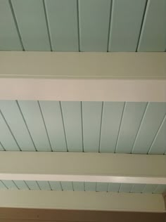 the ceiling is painted white and has three different colored boards on it's sides