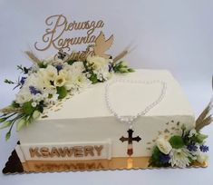 a cake decorated with flowers and a cross