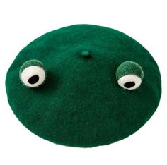 a close up of a green object with two eyes