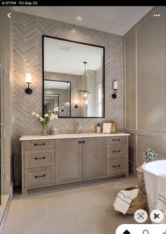 a bathroom with a tub, sink and mirror in it's centerpieces