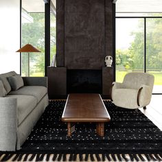 a living room with two couches and a coffee table in front of a fireplace