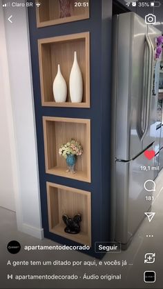 a refrigerator and some shelves with vases on them