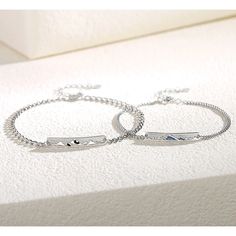 two personalized bracelets are sitting on a white surface with the word love written across them