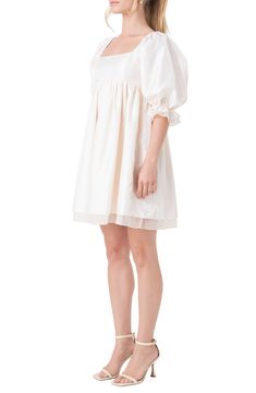 Frill-trimmed puff sleeves frame this square-neck dress designed with a flouncy layered skirt and the option of off-the-shoulder styling. Slips on over head Square neck Elbow-length sleeves Smocked back Lined 100% polyester Hand wash, dry flat Imported Feminine Dress With Ruffle Hem And Balloon Sleeves, White Off-shoulder Puff Sleeve Dress With Ruffles, Feminine Puff Sleeve Dress With Ruffles, Feminine Puff Sleeve Dress With Elastic Sleeves For Spring, Feminine Spring Puff Sleeve Dress With Elastic Sleeves, Feminine Off-shoulder Puff Sleeve Dress With Ruffles, Voluminous Ruffled Feminine Dress, Spring Billowy Puff Sleeve Dress With Pleated Sleeves, Spring Puff Sleeve Dress With Pleated Billowy Sleeves