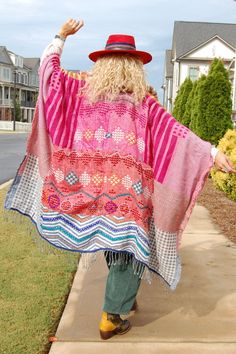 The Noble Balance Poncho in Rose/Blue Combo ♡ Product Highlights ♡ This Noble Balance Poncho in Rose/Blue Combo is the perfect statement and stylish layering piece to add to your closet, and or any on-trend bohemian style outfit! Giving your look a trendy element, this poncho makes a statement with its beautiful multi colored knit and crocheted pattern, a faux fur neck lining, and trendy tassels! This beautiful and luxurious poncho is the perfect piece for the transitional fall to winter season! ✁ Contents & Measurements ✁ This Noble Balance Poncho contains 65% Acrylic, 33% Viscose, and 2% Wool material. Total body length (shoulder to bottom) measures to 45 inches. Bust measurements are 40.5 inches! Measured from one size. For reference the model, and owner Spirit, is wearing one size. Her Pink Bohemian Outerwear For The Beach, Bohemian Pink Outerwear For The Beach, Bohemian Pink Outerwear For Beach, Pink Bohemian Outerwear For Beach, Pink Long Sleeve Outerwear For Vacation, Pink Outerwear For Fall Vacation, Multicolor One Size Poncho For Spring, Pink Summer Outerwear For Day Out, Pink Summer Day Out Outerwear