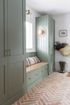 a room with green cupboards and white walls