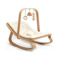 a wooden rocking chair with a white cushion on the bottom and an image of a cloud hanging from it