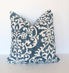 a blue and white pillow sitting on top of a table