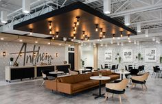 an office lobby with couches, tables and chairs