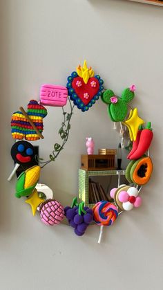 a mirror that is hanging on the wall next to a shelf with some toys in it