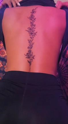 the back of a woman's lower back tattoo