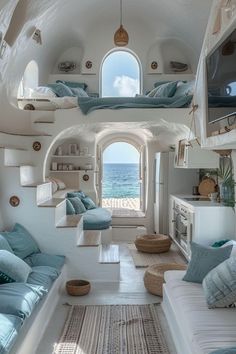 a living room filled with lots of furniture next to an ocean front window and skylight