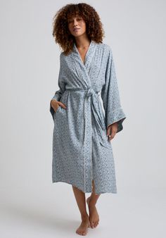 The charming Corina robe is cut from our inimitable cotton and adorned with an interesting blue Ditsy floral print. This oversized kimono-inspired robe boasts fluted sleeves and a detachable belt, creating a flattering silhouette. Contrast piping on the cuff and neck, complete this effortlessly feminine piece.    Cool machine wash only. Wash inside out and with similar colours 100% Cotton Modal   Cool machine wash only. Wash inside out and with similar colours Oversized Kimono, Fluted Sleeves, Luxury Scarves, Printed Robe, Floral Robes, Nightwear Women, Ditsy Floral Print, Contrast Piping, Kimono Style