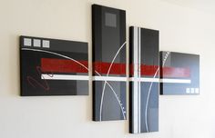 three black and red paintings hanging on the wall next to each other in a room