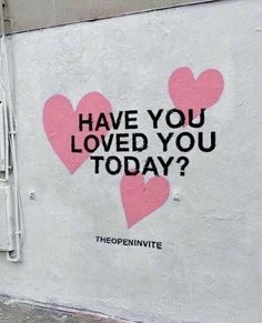 a white wall with pink hearts painted on it and the words have you loved you today?