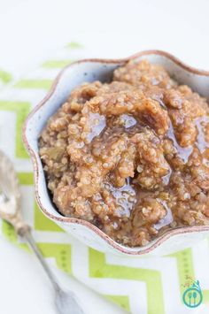 a bowl filled with oatmeal sitting on top of a table