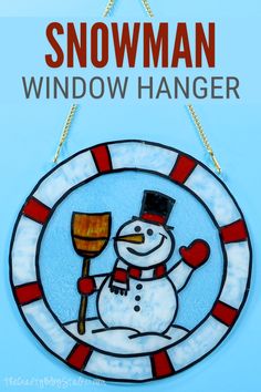 a stained glass snowman window hanging on a blue wall