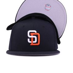 New Era Cap 59Fifty fitted hat for the San Diego Padres in navy blue and orange colorway, featuring interlocking SD logo on the front. This 90s throwback is all business. Officially colored with clean lines all throughout, this fitted is proof that simplicity goes a long way. Grab yours today! Hat Material: 100% WoolCrown: NavyVisor: NavyButton: NavyUndervisor: GreyFront Logo: Snow White/OrangeadeNew Era Flag: Midnight NavyRear Logo: Midnight Navy/Snow White/Orangeade Sd Logo, 90s Throwback, World Baseball Classic, San Diego Chargers, San Antonio Spurs, San Diego Padres, New Era Cap, New Era 59fifty, Oakland Athletics