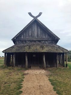 an old wooden building with a cross on top