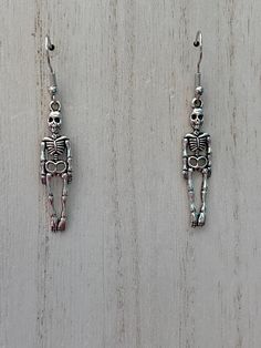 Alloy Skeleton Earrings. All products are lead and nickel free and also hypoallergenic. Nickel-free Bone Dangle Earrings, Bone Colored Earrings With Ear Wire For Gift, Nickel-free Bone-colored Dangle Earrings, Nickel Free Bone Color Dangle Earrings, Halloween Hypoallergenic Metal Jewelry, Silver Skull Earrings For Halloween, Adjustable Nickel-free Earrings For Halloween, Bone Colored Metal Earrings For Pierced Ears, Novelty Metal Earrings With Ear Wire