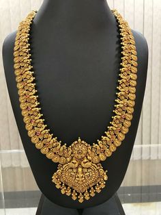 an elaborate gold necklace on display