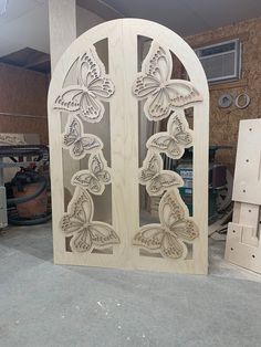 an intricately carved wooden door with butterflies on it