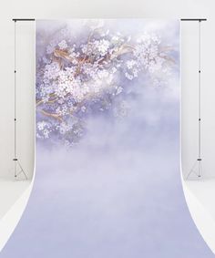 a white and blue backdrop with flowers on it