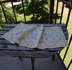 two pieces of cloth sitting on top of a wooden bench