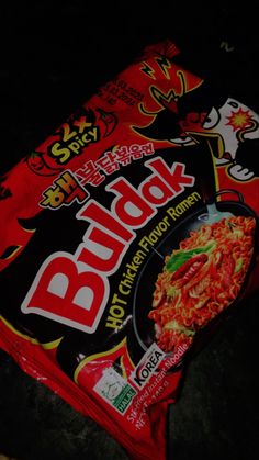 a bag of food sitting on top of a black floor next to a red and white sign