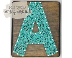 a string art kit with the letter a in it's center and an ad that says do it yourself