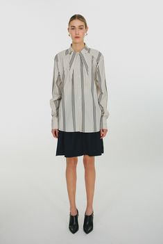 Oversized boxy button down shirt with dropped shoulder, high cuffs and notch collar in cotton. DETAILS Color: Pearl Button down shirt Notch collar Oversized Long sleeves Made in Europe MATERIALS 100% cotton SIZING & FIT Regular fit. True to size. Oversized Striped Shirt, Notch Collar, Notched Collar, Striped Shirt, Button Downs, High Neck Dress, Button Down Shirt, Long Sleeves, Collar