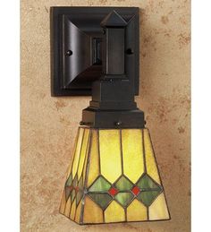 a wall light with a stained glass shade