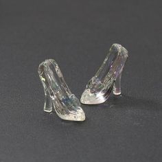 pair of clear high heeled shoes sitting on top of a table